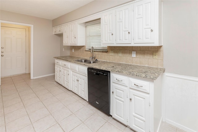 kitchen with white cabinetry, tasteful backsplash, a sink, light tile patterned flooring, and black dishwasher