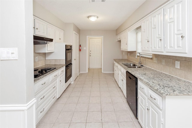 kitchen featuring tasteful backsplash, under cabinet range hood, white cabinets, black appliances, and a sink