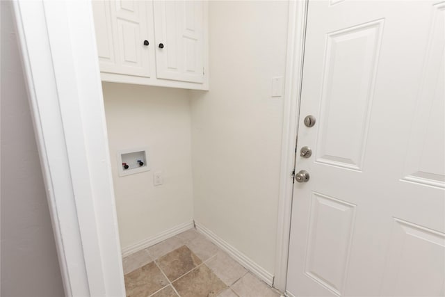 laundry area featuring baseboards, hookup for a washing machine, and cabinet space