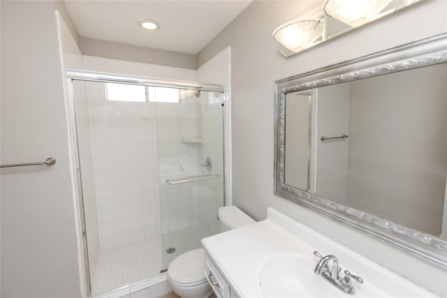 bathroom with vanity, toilet, and a shower stall