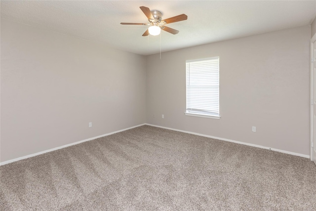unfurnished room with carpet, ceiling fan, and baseboards
