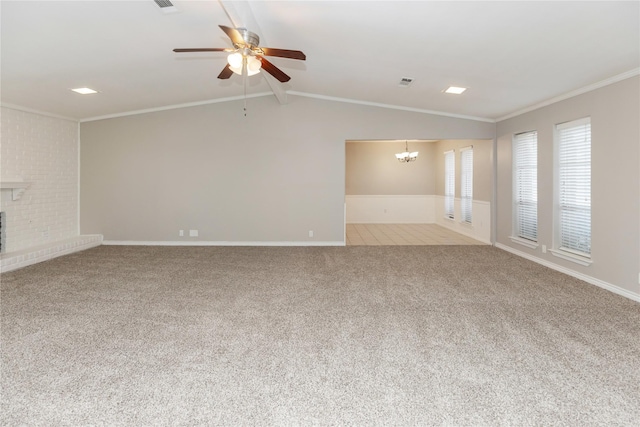 unfurnished living room with carpet flooring, a fireplace, crown molding, lofted ceiling, and ceiling fan with notable chandelier