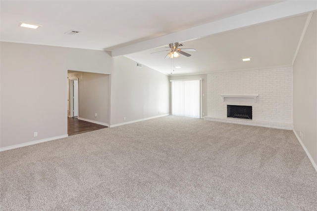 unfurnished living room with ceiling fan, lofted ceiling with beams, baseboards, carpet floors, and a brick fireplace