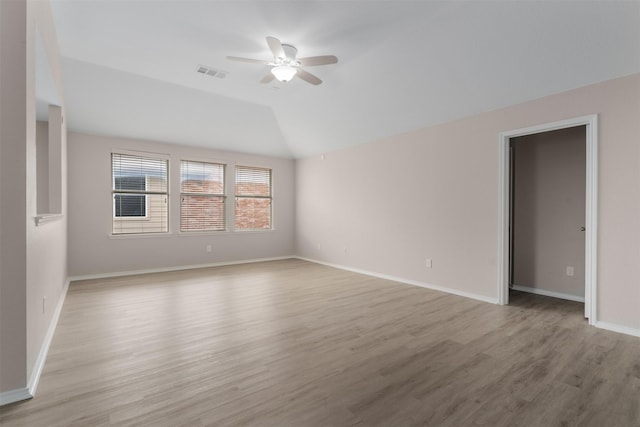 13140 Fencerow Rd, Fort Worth, TX 76244 - empty room with a ceiling fan, baseboards, wood finished floors, vaulted ceiling, and visible vents