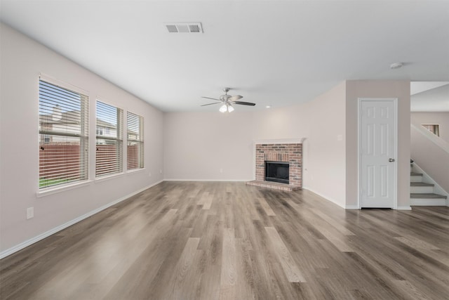 13140 Fencerow Rd, Fort Worth, TX 76244 - unfurnished living room featuring a ceiling fan, visible vents, wood finished floors, stairway, and baseboards