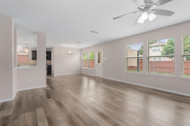 13140 Fencerow Rd, Fort Worth, TX 76244 - unfurnished living room with visible vents, a ceiling fan, baseboards, and wood finished floors