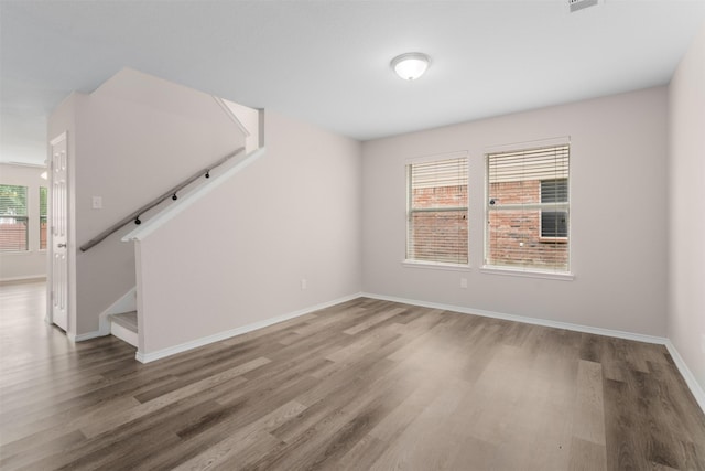 13140 Fencerow Rd, Fort Worth, TX 76244 - unfurnished living room featuring baseboards, wood finished floors, and stairway