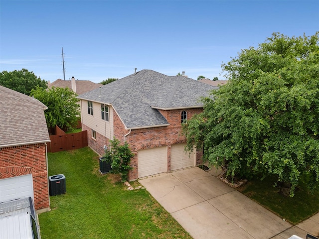 13140 Fencerow Rd, Fort Worth, TX 76244 - view of front of house featuring an attached garage, central AC, brick siding, a front yard, and driveway