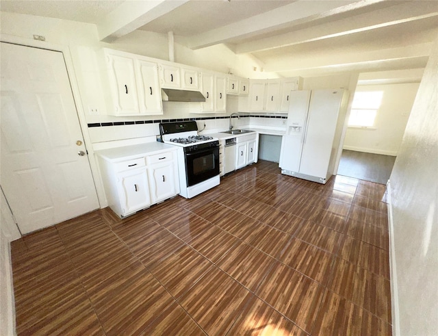 kitchen featuring white cabinets, a sink, light countertops, under cabinet range hood, and white appliances