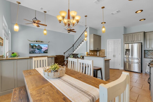 6107 Grande Cove Ct, Granbury, TX 76049 - dining space featuring visible vents, light tile patterned floors, ceiling fan with notable chandelier, and stairs