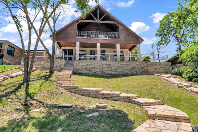 6107 Grande Cove Ct, Granbury, TX 76049 - rear view of property with stone siding, a balcony, and a lawn