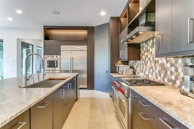 1505 Cottonwood Valley Cir N, Irving, TX 75038 - kitchen featuring high end appliances, wall chimney range hood, a sink, decorative backsplash, and recessed lighting