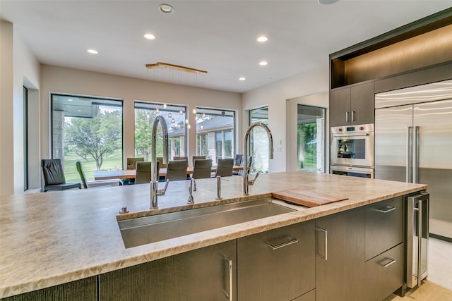 1505 Cottonwood Valley Cir N, Irving, TX 75038 - kitchen with a sink, stainless steel appliances, recessed lighting, light countertops, and beverage cooler