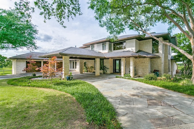 1505 Cottonwood Valley Cir N, Irving, TX 75038 - prairie-style home featuring concrete driveway, stone siding, and a front lawn