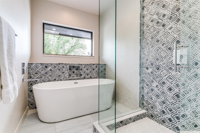 1505 Cottonwood Valley Cir N, Irving, TX 75038 - bathroom with a shower stall, a freestanding tub, and tile walls
