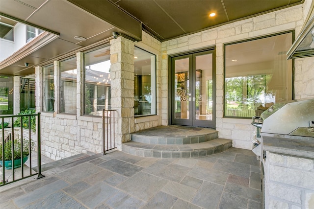1505 Cottonwood Valley Cir N, Irving, TX 75038 - doorway to property featuring french doors, stone siding, and area for grilling