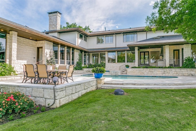 1505 Cottonwood Valley Cir N, Irving, TX 75038 - rear view of house featuring a patio area, a chimney, an outdoor pool, a lawn, and stucco siding