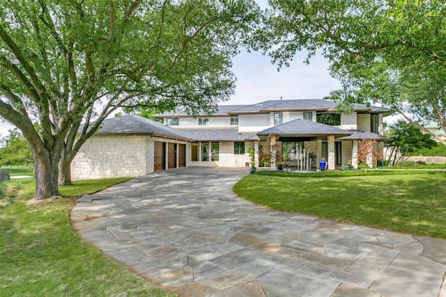 1505 Cottonwood Valley Cir N, Irving, TX 75038 - prairie-style home featuring concrete driveway, stone siding, a garage, and a front lawn