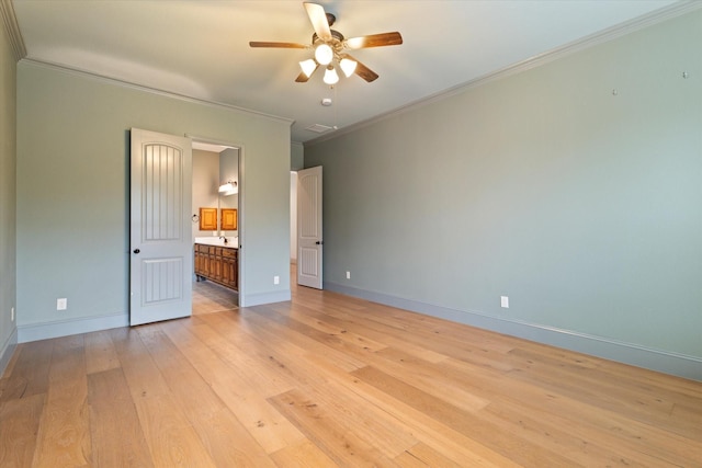 unfurnished bedroom featuring baseboards, ornamental molding, light wood-style flooring, and connected bathroom