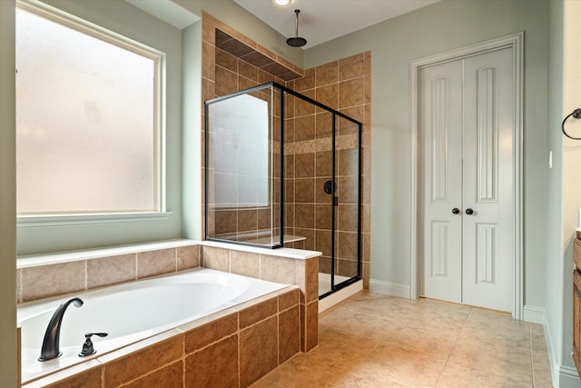 bathroom with a garden tub, tile patterned floors, and a stall shower