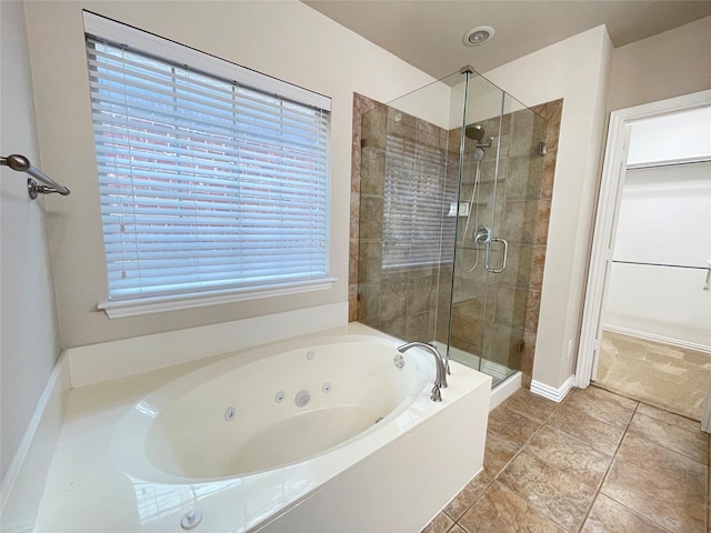 3617 Timothy Dr, Flower Mound, TX 75022 - bathroom with a shower stall, a whirlpool tub, a walk in closet, baseboards, and tile patterned flooring