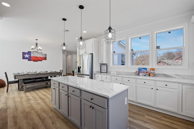 7407 County Road 964, Nevada, TX 75173 - kitchen with wood finished floors, gray cabinetry, stainless steel refrigerator with ice dispenser, a notable chandelier, and crown molding