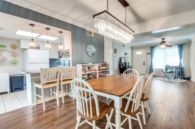 2914 Harvard St, Irving, TX 75062 - dining space with ceiling fan, visible vents, ornamental molding, and wood finished floors