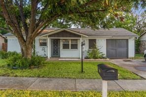 ranch-style home with driveway, a front yard, and a garage