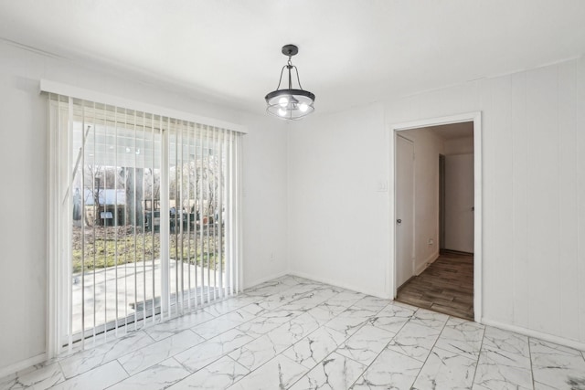 unfurnished dining area with a wealth of natural light and marble finish floor