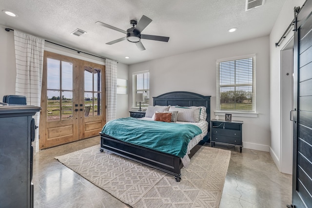 1400 Lacy Dr, Lipan, TX 76462 - bedroom with a barn door, visible vents, finished concrete flooring, and a textured ceiling
