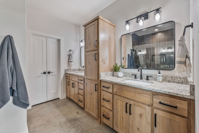 1400 Lacy Dr, Lipan, TX 76462 - bathroom with double vanity, a sink, a shower stall, and concrete flooring