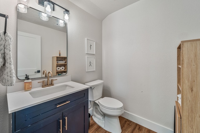 1400 Lacy Dr, Lipan, TX 76462 - bathroom featuring toilet, wood finished floors, vanity, and baseboards