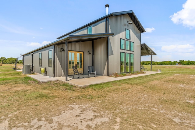 1400 Lacy Dr, Lipan, TX 76462 - back of property with a lawn, central air condition unit, and a patio area