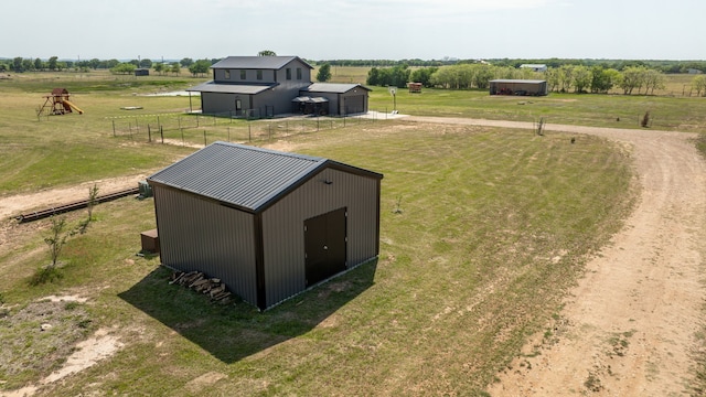 1400 Lacy Dr, Lipan, TX 76462 - exterior space featuring an outdoor structure, a rural view, an outbuilding, a lawn, and fence