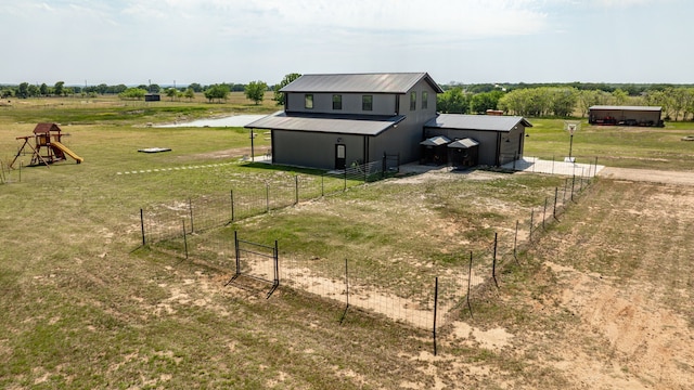 1400 Lacy Dr, Lipan, TX 76462 - rear view of house featuring metal roof, an outdoor structure, a rural view, and a lawn