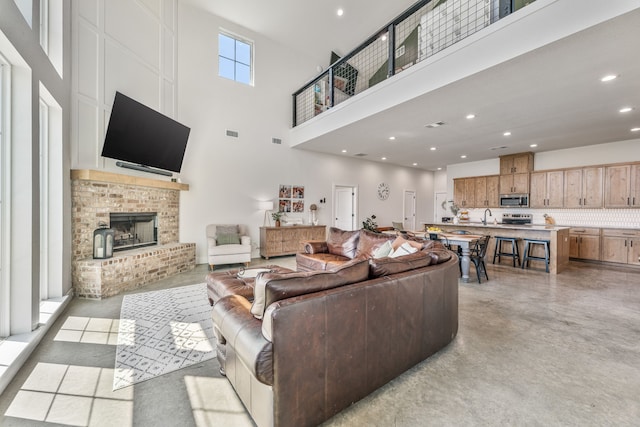 1400 Lacy Dr, Lipan, TX 76462 - living area featuring visible vents, recessed lighting, concrete flooring, a brick fireplace, and a towering ceiling