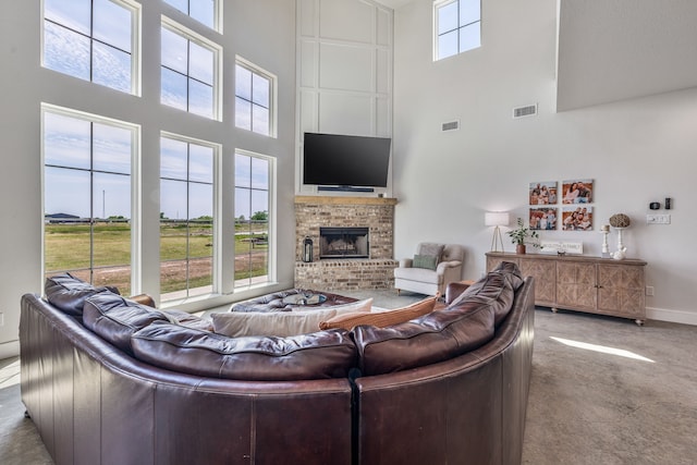 1400 Lacy Dr, Lipan, TX 76462 - living area with a brick fireplace, a towering ceiling, visible vents, and baseboards