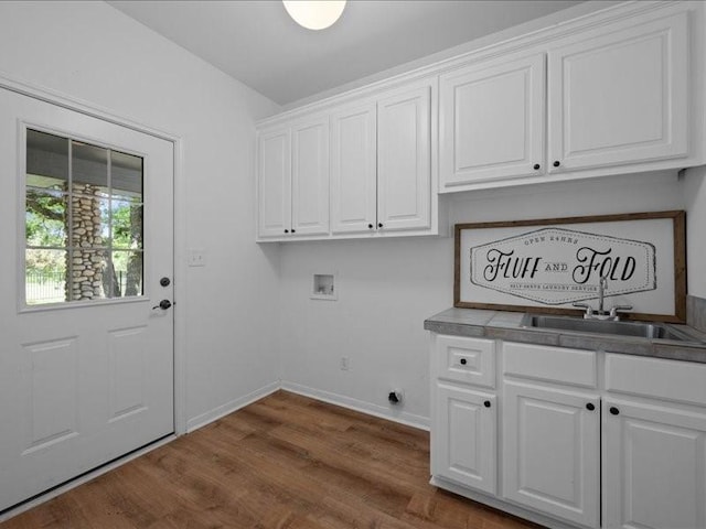 8313 Jonquil Dr, Waco, TX 76708 - laundry area featuring baseboards, dark wood finished floors, cabinet space, a sink, and washer hookup