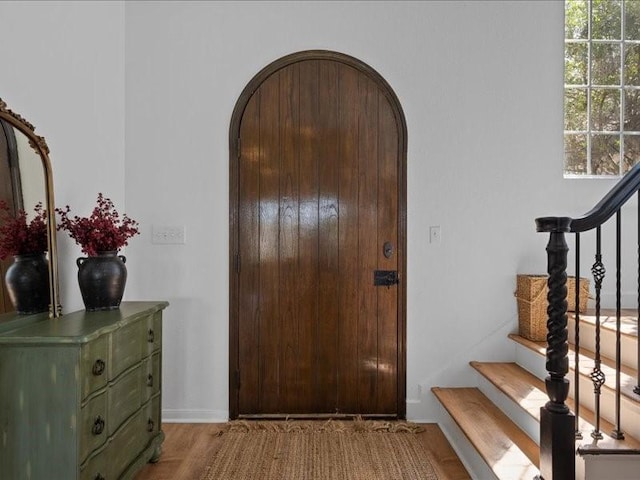 8313 Jonquil Dr, Waco, TX 76708 - entrance foyer with arched walkways, stairs, and wood finished floors