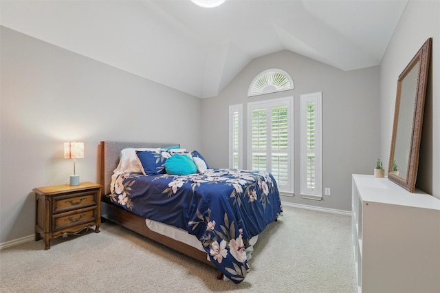 bedroom with baseboards, carpet flooring, and lofted ceiling