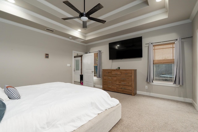 bedroom with a raised ceiling, crown molding, visible vents, light carpet, and baseboards