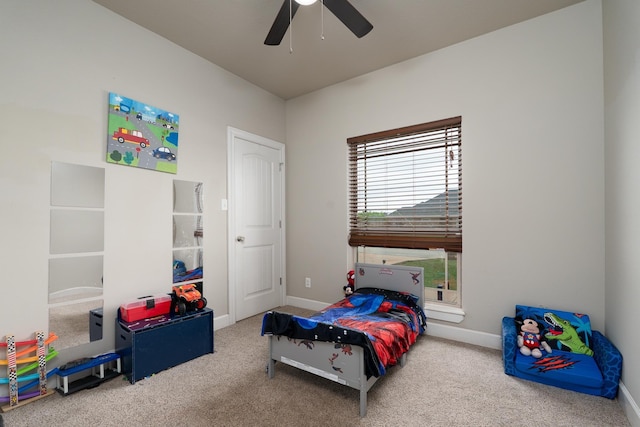 carpeted bedroom with a ceiling fan and baseboards