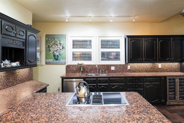 4310 Rawlins St, Dallas, TX 75219 - kitchen featuring beverage cooler, black electric stovetop, dark cabinets, and a sink
