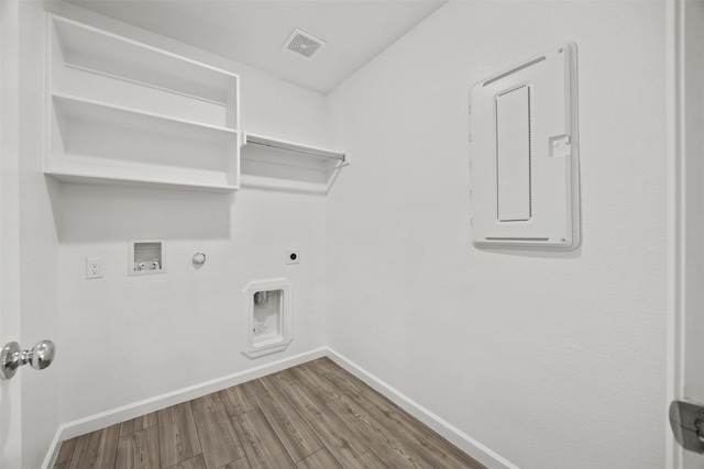 clothes washing area featuring laundry area, electric dryer hookup, hookup for a gas dryer, baseboards, and visible vents