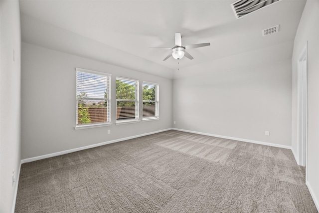 unfurnished room with carpet flooring, visible vents, and ceiling fan