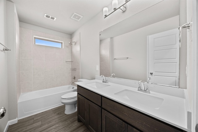 full bathroom featuring toilet, a sink, and visible vents