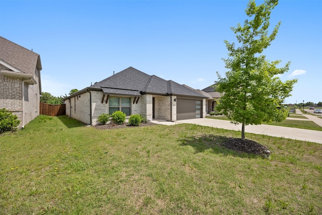 ranch-style house featuring brick siding, fence, roof with shingles, concrete driveway, and an attached garage