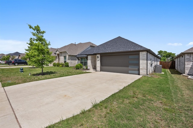 view of front of property with central AC, brick siding, fence, and a front lawn