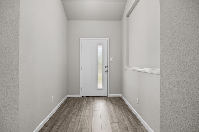 entrance foyer with wood finished floors and baseboards