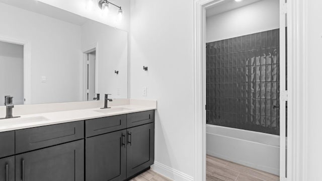 1620 Keneipp Rd, Carrollton, TX 75006 - bathroom featuring baseboards, double vanity, a sink, and wood finished floors